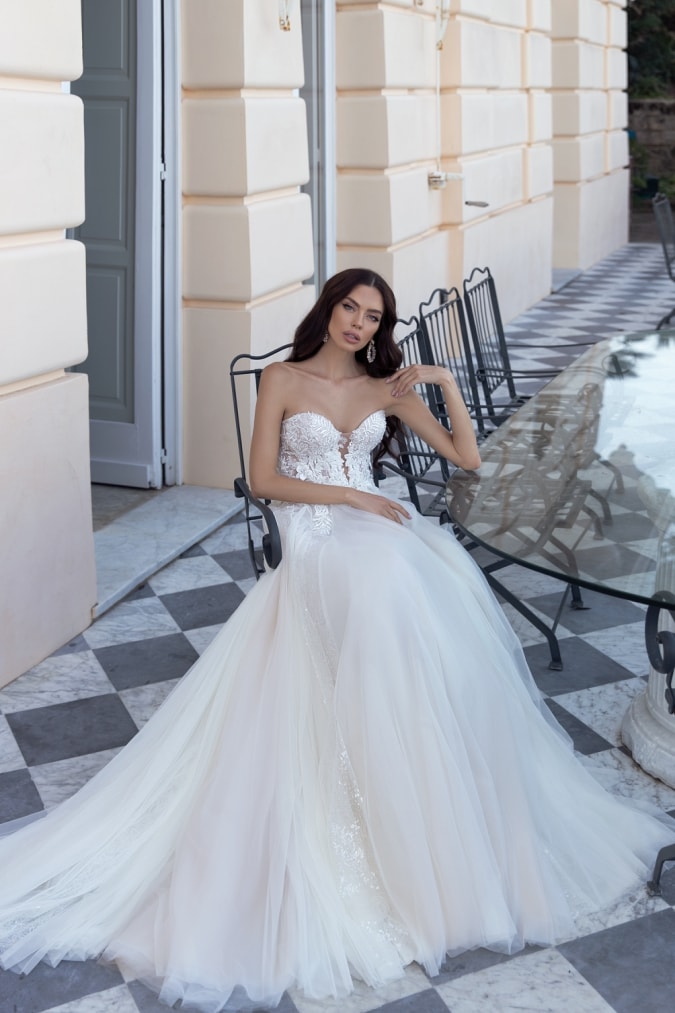 Woman wearing a strapless wedding dress on terrace