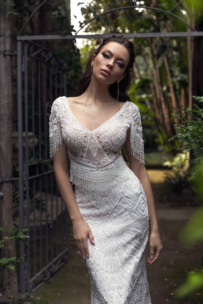 Close up of fitted lace wedding dress with half sleeves