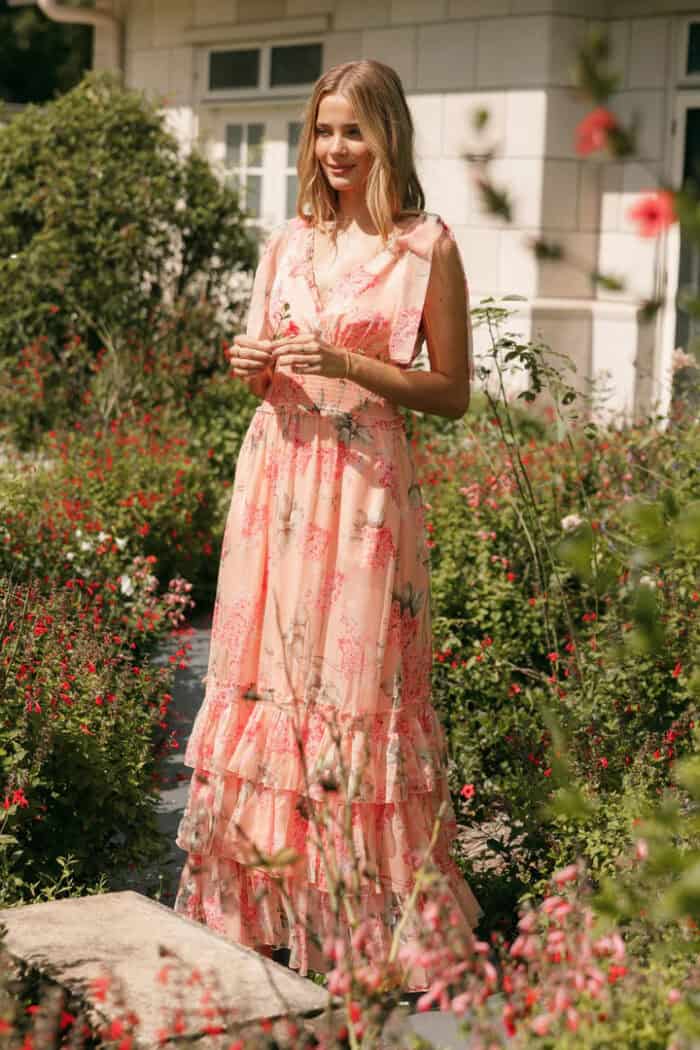 Peach floral sleeveless gown on a model