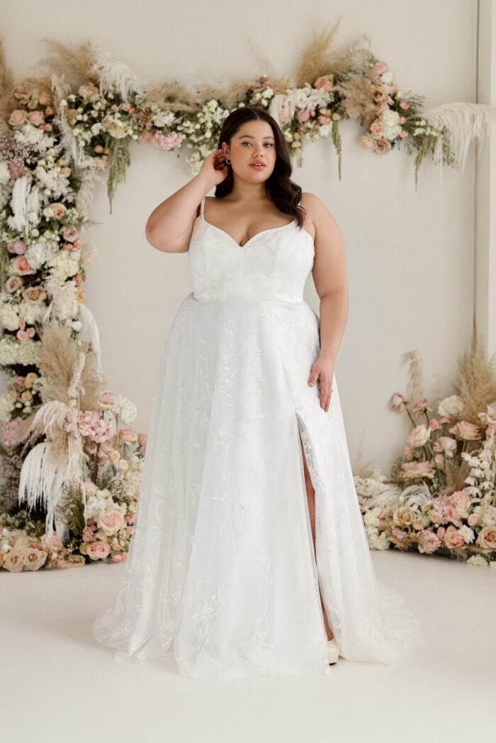 Model wearing a spaghetti strap wedding dress with sweetheart neckline