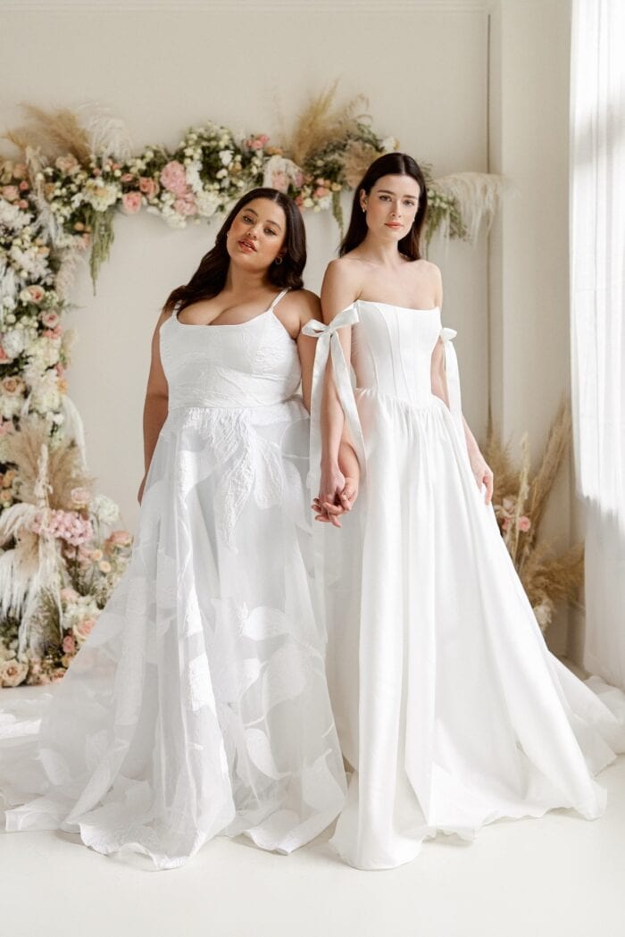 Two models showing wedding dresses from the Truvelle collection